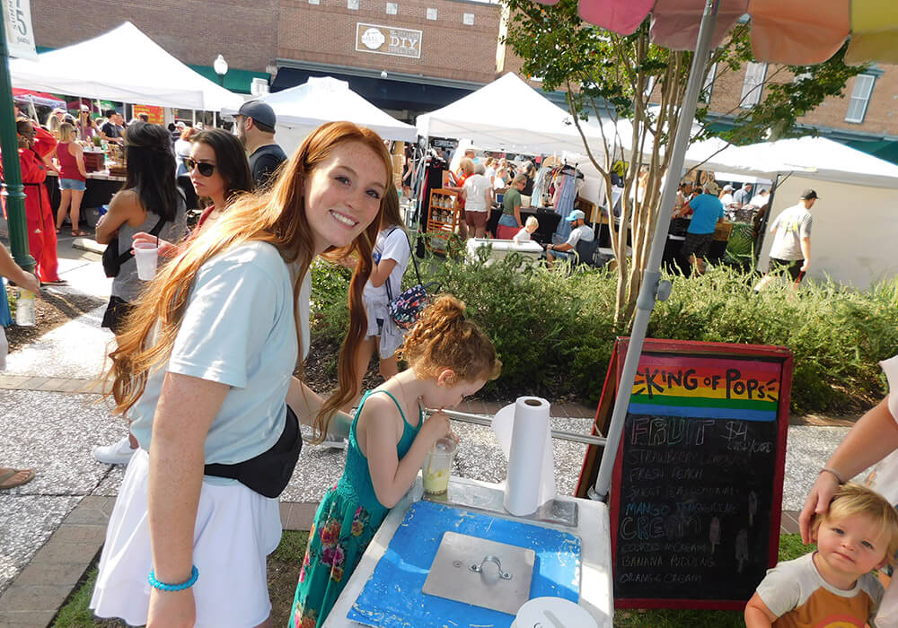 Visitors browse vendor tents at the Sweet Tea Festival